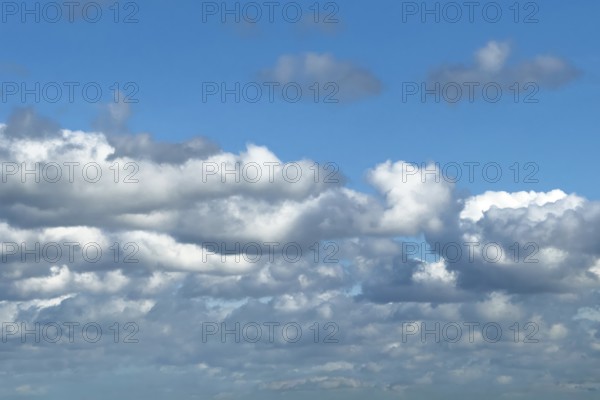 Sky below covered by white partly grey clouds Stratocumulus covered above cheerful to slightly cloudy with Altocumulus against a blue sky, international