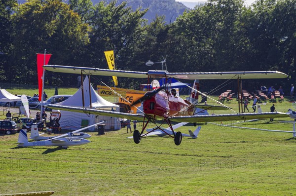 A De Havilland DH.82 Tiger Moth with the registration HB-UPM during a flight demonstration as part of an air show on Rossfeld in Metzingen-Glems, Baden-Württemberg, Germany, for editorial use only