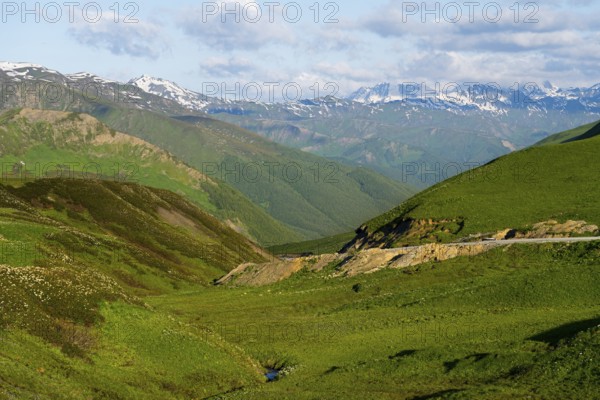Panorama of a mountainous landscape with green hills and a road, Zagari Pass, Svaneti, Greater Caucasus, High Caucasus, Georgia