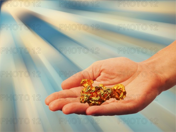 Symbolic photo, hand with gold nugget, stable value, risks, crash or upswing, financial economy, stock market, Trump as a risk for USA, banks, money flows, currency devaluation, euro policy, inflation, stagnation, profits, capital market, currency, ECB, euro, euro upswing, euro downturn, parity, dollar, reserve currency, bitcoin, interest, debt, European Community, Germany