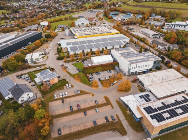 Industrial area with large buildings and parking spaces in an autumn environment, Dornstetten, Freudenstadt district, Germany