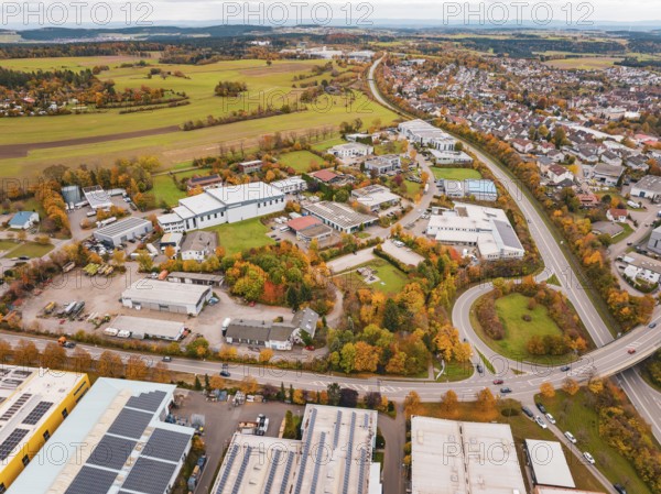 Aerial view of a city with industrial buildings, roads and autumn landscape, Dornstetten, Freudenstadt district, Germany