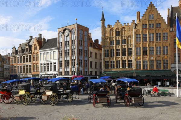 Historic houses on the market square in the old town of Bruges with horse-drawn carriages, Grote Markt, UNESCO World Heritage Site, Flanders, Belgium