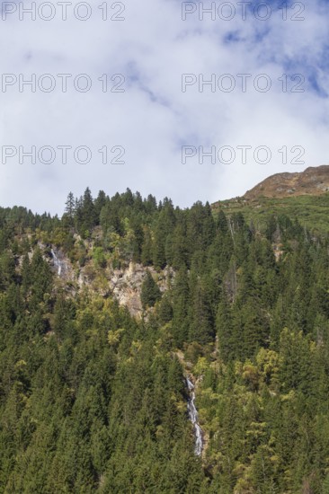 Waterfall with forest and mountains on Wilde Wasser Weg in autumn, WildeWasserweg, Stubai Valley, Tyrol, Austria