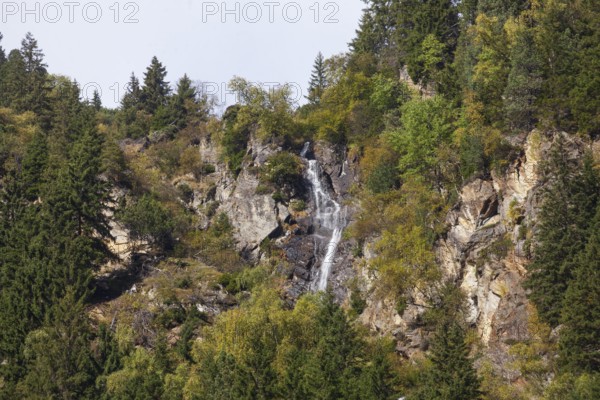 Waterfall with forest and mountains on Wilde Wasser Weg in autumn, WildeWasserweg, Stubai Valley, Tyrol, Austria