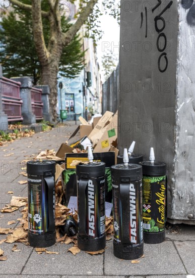 Empty cartridges filled with N2O, nitrous oxide gas, called laughing gas, officially it serves as a propellant to produce whipped cream in appropriate devices, but is often used as an intoxicant, party drug, misused, here mass, illegal disposal in addition to waste paper containers in Düsseldorf, North Rhine-Westphalia, Germany