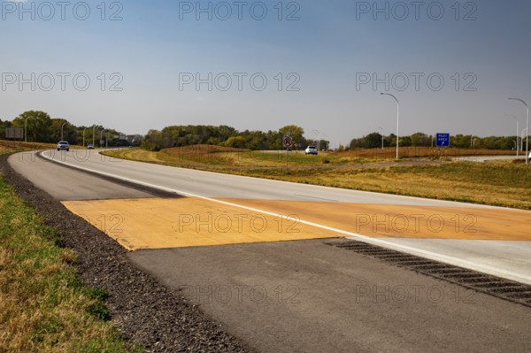 Blue Earth, Minnesota - A 'Golden Stripe' of yellow pavement marks the spot where Interstate 90 was completed in 1978. Stretching 3, 099 miles from Boston to Seattle, I-90 is the longest U.S. Interstate highway. 'Golden Stripe' recalls the 1869 'Golden Spike' of the first transcontinental railroad