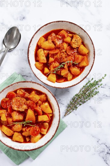 Meat goulash with potatoes and carrots, sweet peppers, in a saucepan, top view, traditional Hungarian soup, homemade, no people