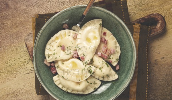 Dumplings, with fried prosciutto, a traditional dish of Polish cuisine, dumplings, top view, close-up, without people