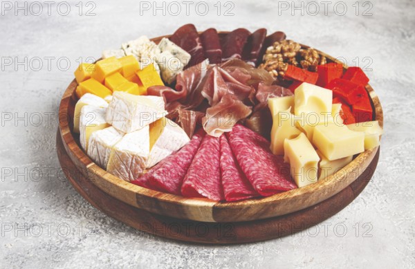 Assortment of cheese meat cuts, on a plate, top view, no people