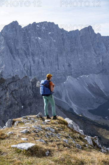 Female hiker on hiking trail, hiking to Gamsjoch, behind Dreizinkenspitze and Laliederer Wand, eastern Karwendel, Tyrol, Austria