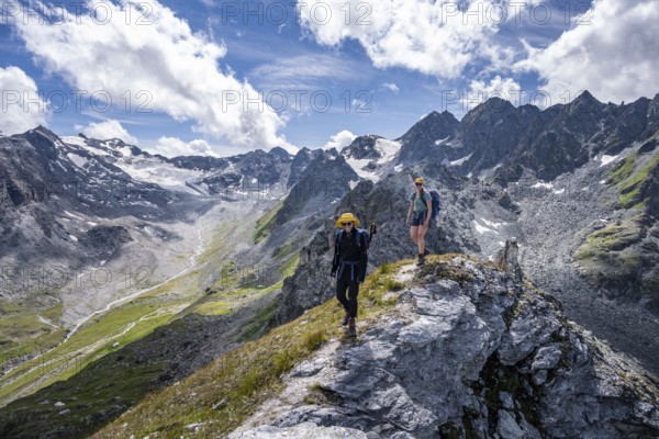 Two mountaineers on a mountain ridge, climbing to the summit of Mont de la Blana, view of rocky mountain landscape, Hérménence, Valais Alps, Switzerland