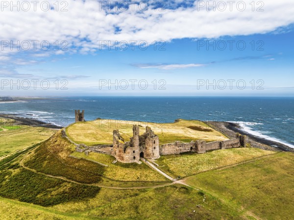Dunstanburgh Castle from a drone, Northumberland Coast, England, United Kingdom