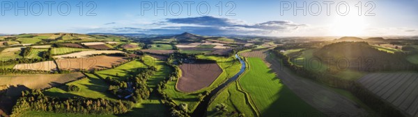 Panorama of evening Fields and Farms over River Teviot and Minto Crags from a drone, Roxburghshire, Scottish Borders, Scotland, UK