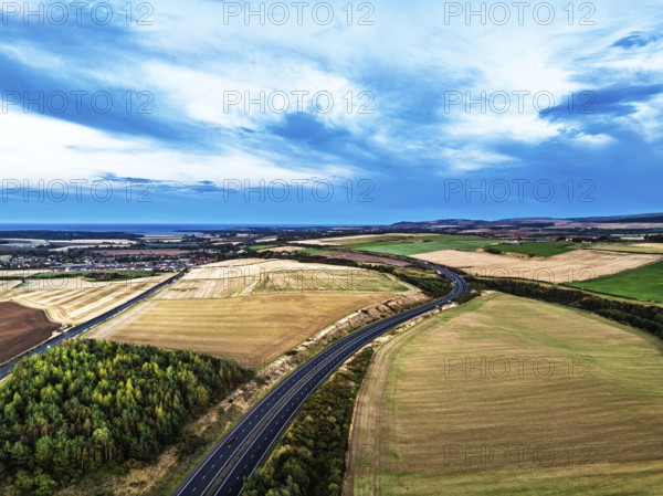 Sunset of Fields and Farms over Traprain Law and Hailes Castle from a drone, River Tyne, Haddington, East Lothian, Scotland, UK