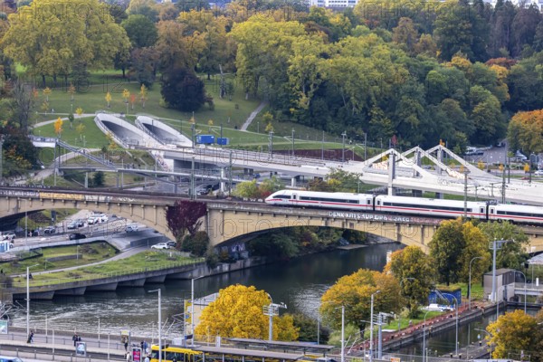 Bridges across the Neckar in Bad Cannstatt with Rosenstein Park. The ICE is still running on the old Rosenstreinbrücke. When the new main train station is completed, the trains will travel across the new Neckar bridge behind it. Stuttgart, Baden-Württemberg, Germany