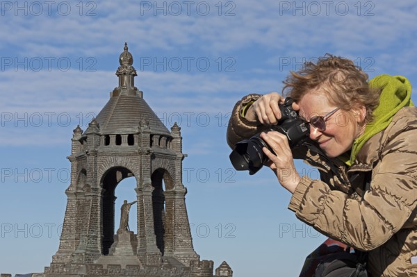 Woman photographing model, Kaiser Wilhelm Memorial, Porta Westfalica, North Rhine-Westphalia, Germany