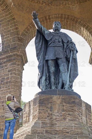 Woman photographing statue, Kaiser Wilhelm Memorial, Porta Westfalica, North Rhine-Westphalia, Germany