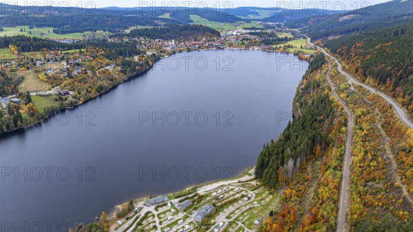 Titisee in the Black Forest around autumn. The landscape around the lake is in bright autumn colors. Drone photo. Titisee-Neustadt, Baden-Württemberg, Germany