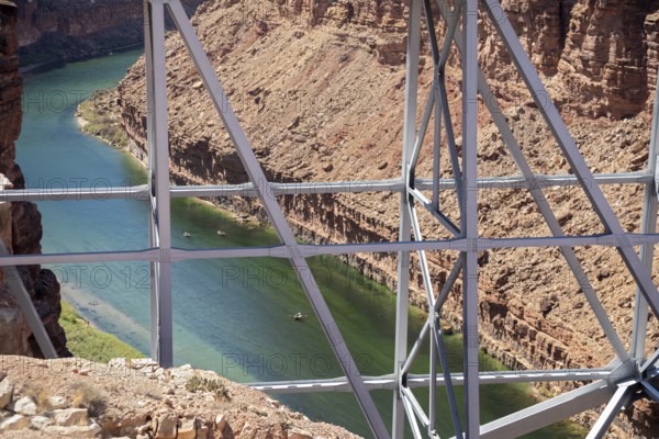 Marble Canyon, Arizona - Dories float under the Navajo Bridge which spans the Colorado River in Marble Canyon, headed towards the Grand Canyon