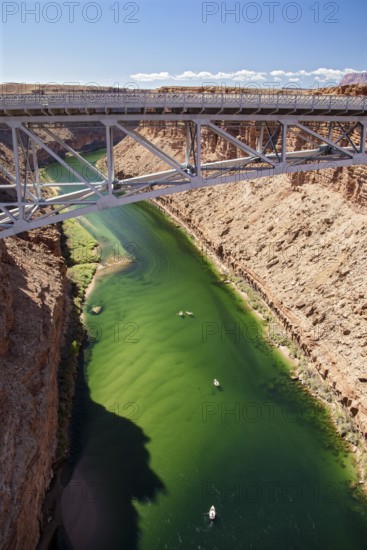 Marble Canyon, Arizona - Dories float under the Navajo Bridge which spans the Colorado River in Marble Canyon, headed towards the Grand Canyon