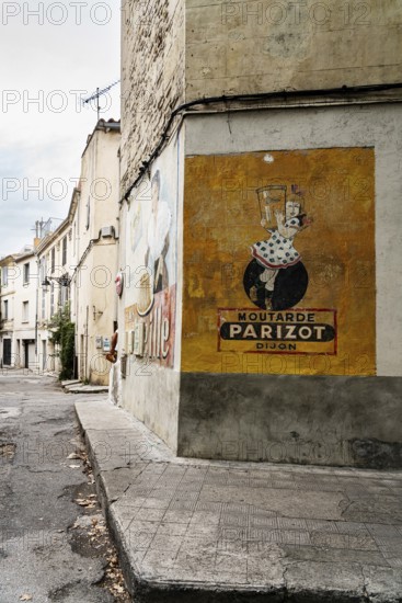 Wall painting, 1950s, advertisement, corner house with old advertisement, Arles, France