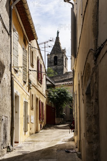 Alley and church tower, Arles, France