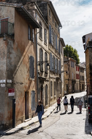 Alley, walkers, houses, shades of orange, Arles, France