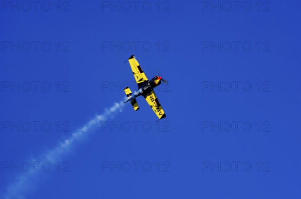 A Votec 351 sport aircraft from the Swiss MSW Aviation AG with registration HB-YMV during a flight demonstration as part of an air show on Rossfeld in Metzingen-Glems, Baden-Württemberg, Germany, for editorial use only