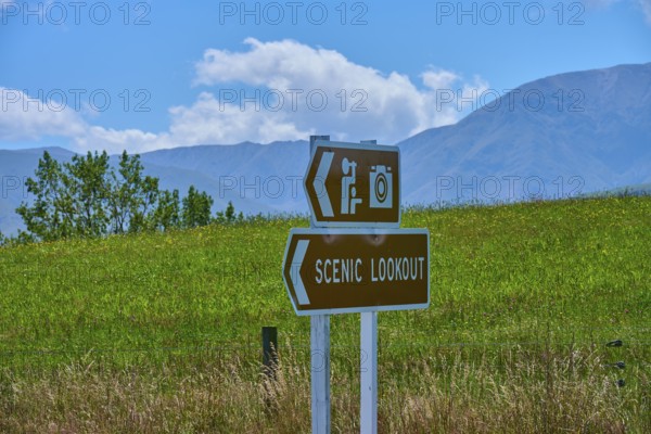 Scenic Lookout sign with photo camera icon against green mountain landscape, Geraldine Fairlie Lookout, Geraldine, Canterbury, South Island, New Zealand
