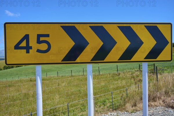 Road sign with arrows and number 45 in front of green landscape, Geraldine Fairlie Lookout, Geraldine, Canterbury, South Island, New Zealand