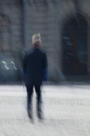 Abstract of a man walking with cruthces captured using ICM intentional camera movement technique, Helsinki, Finland