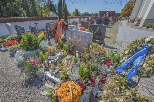 Cemetery with fresh graves in Maria-Thann, Allgäu, Swabia, Bavaria, Germany