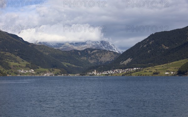 The town of Reschen on Lake Reschen in Italy is surrounded by impressive mountains