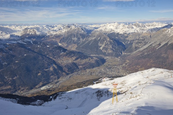 The town of Bormio is nestled in the Ortler-Cevedale mountain range in Italy. The landscape is characterized by high and snow-capped mountains