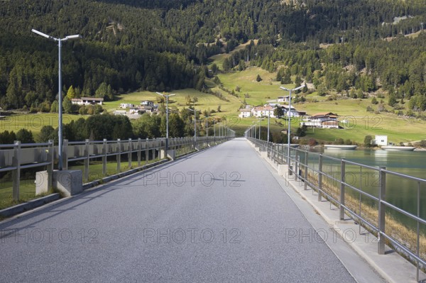 There is a narrow road on the dam that dams Lake Reschen in South Tyrol in Italy