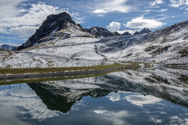 Kanzelwand is reflected in the reservoir, Kanzelwand snow-making pond, mountains of the Allgäu Alps behind, Vorarlberg, Austria