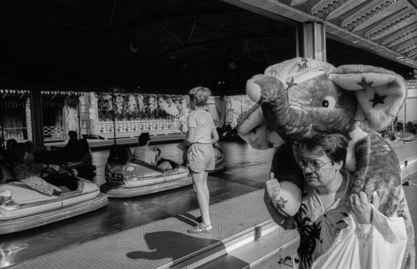 Germany, Berlin, 01.8.1992, hustle and bustle on Marx-Engels-Platz, bumper car, man with caught elephant
