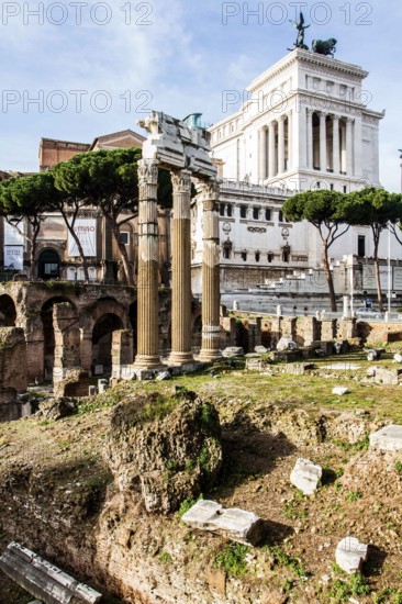 Forum of Caesar (Foro di Cesare), built between 1st century BC and 2nd century AD, with the colums of the Temple of Venus Genetrix in front and the Monument to Vittorio Emanuele II in the background. Rome, Province of Rome, Italy