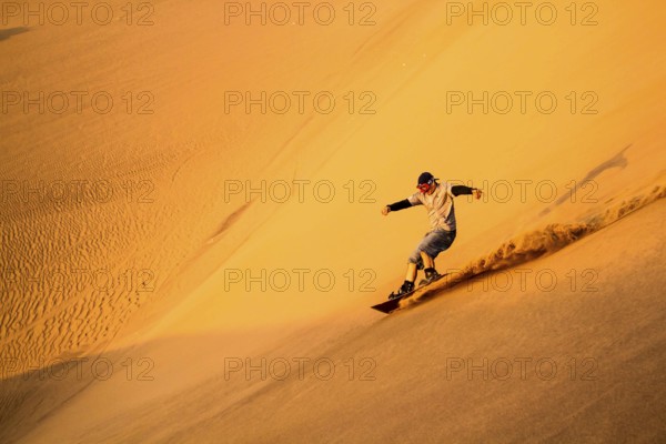 Sandboarding on Caramucho dunes, in Atacama Desert. Iquique, Tarapaca Region, Chile. 21.11.15