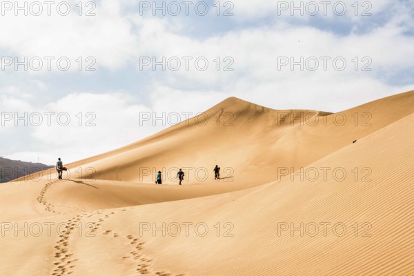 Sandboarders in Cerro Dragon, in Atacama Desert. Iquique, Tarapaca Region, Chile. 18.11.15