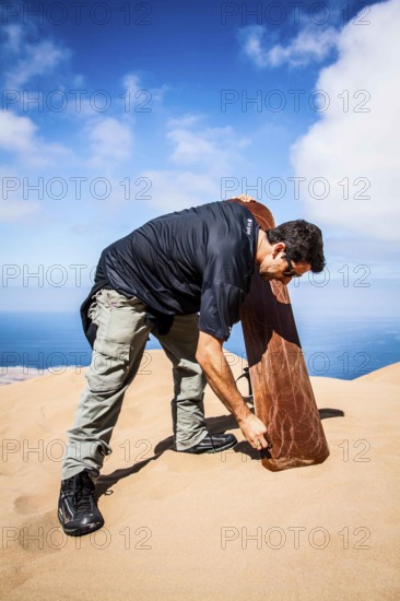 Sandboarder in Alto los Verdes, in Atacama Desert. Iquique, Tarapaca Region, Chile. 19.11.15