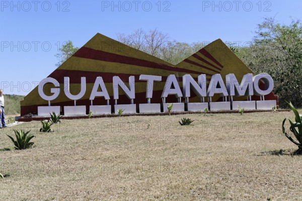 Large sign with 'Guantánamo' in a meadow surrounded by nature, Cuba, Greater Antilles, Caribbean, Central America, America, Central America