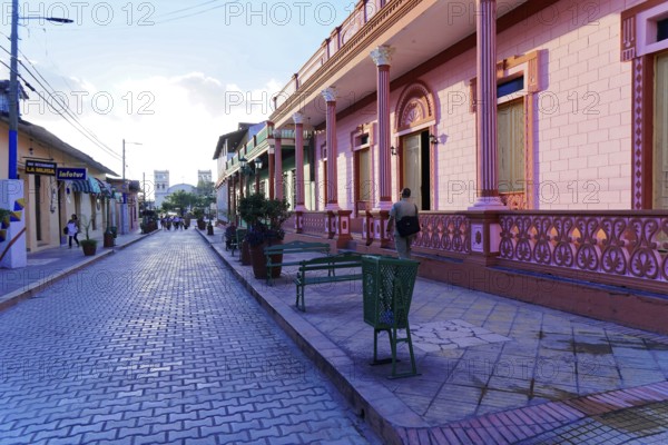 Baracoa, Cuba, Central America, colorful colonial buildings and a paved street under a clear sky, Greater Antilles, Caribbean, America, Central America