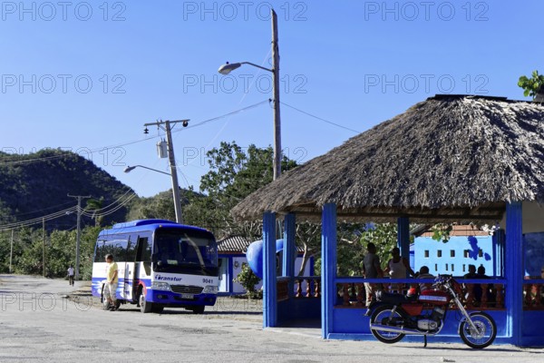 Baracoa, Cuba, Central America, bus and motorbike at a thatched roof bus stop in a rural area, Greater Antilles, Caribbean, America, Central America