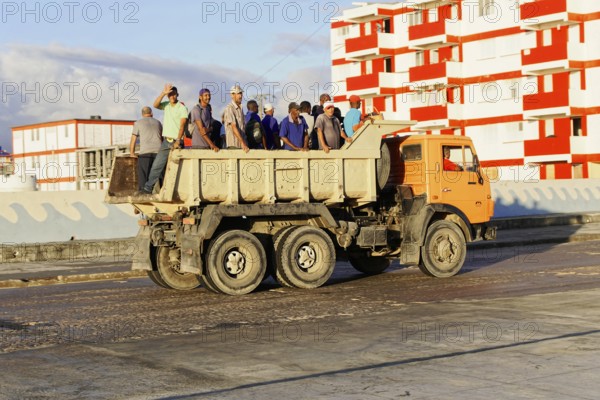 Baracoa, Cuba, Central America, Open truck loaded with workers on a wide, empty road, Greater Antilles, Caribbean, America, Central America