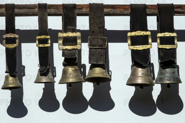 Cowbells hanging on a house wall, Schwand, Stillachtal, near Oberstdorf, Oberallgäu, Allgäu, Bavaria, Germany