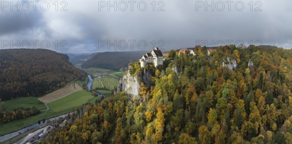 Aerial view, panorama of Werenwag castle and former castle on a rocky spur in the upper Danube Valley, surrounded by autumnal vegetation and clouds of fog, Sigmaringen district, Baden-Württemberg, Germany