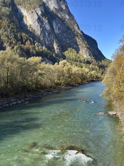 A lively river flows between steep mountains, surrounded by autumn leaves, Drau, Drauradweg, near Lienz, Tyrol, Austria