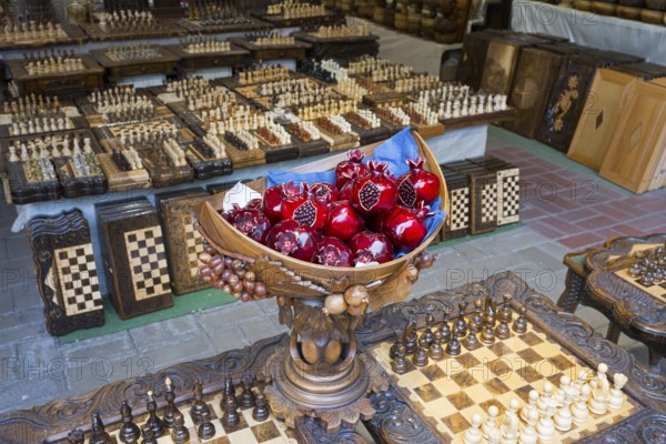 Colourful pomegranates in intricately carved wooden balls on checkerboards, Vernissage Market, Craftsmen's Market, Yerevan, Yerevan, Armenia
